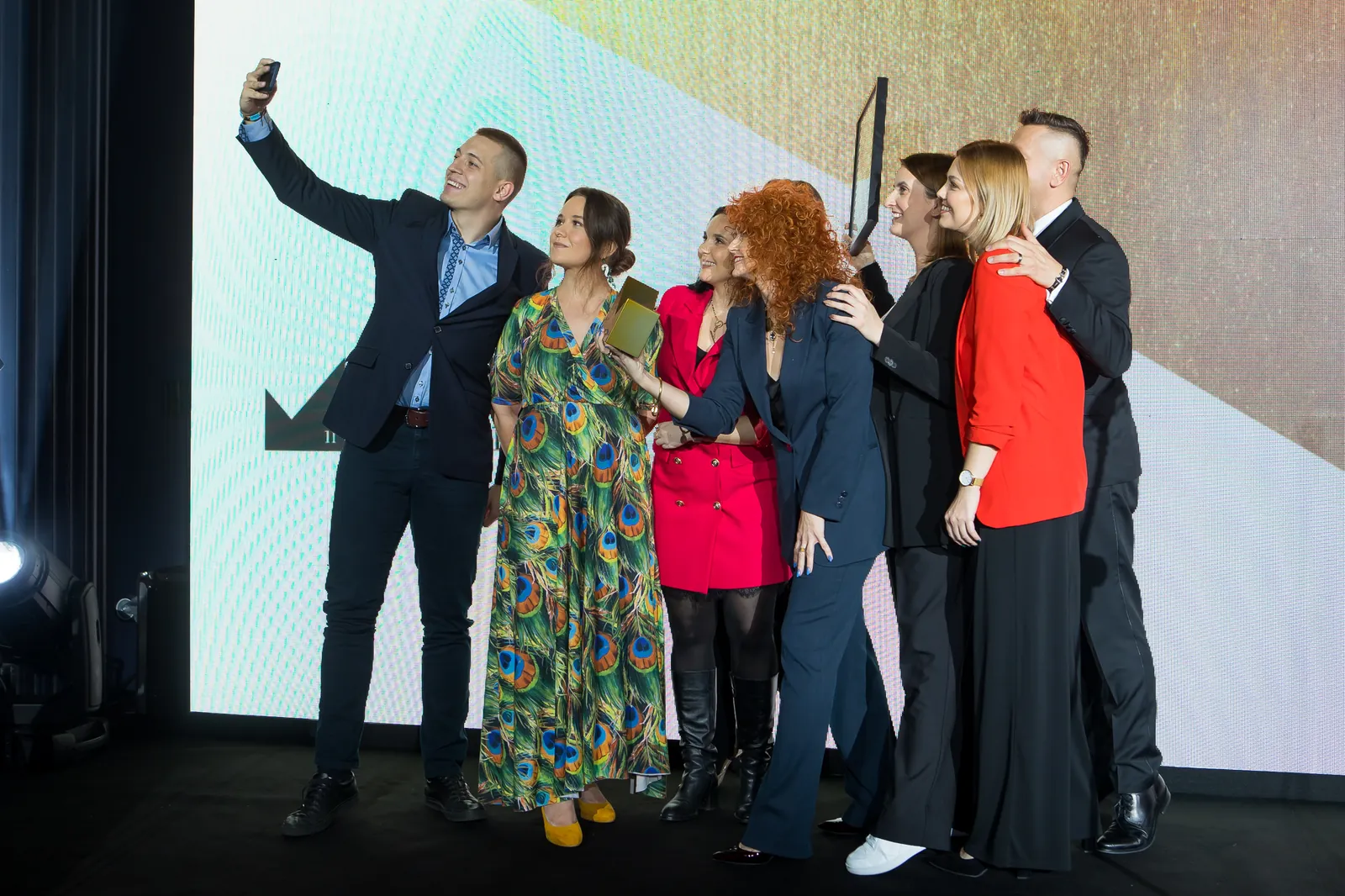 A winning team takes a selfie on the Gala stage
